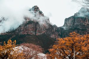 the franschhoek mountains in winter with brown trees and clouds