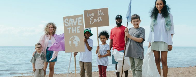 a group of volunteers cleaning a beach