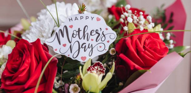 Happy Mothers Day text on gift card with flower bouquet of roses, tulips