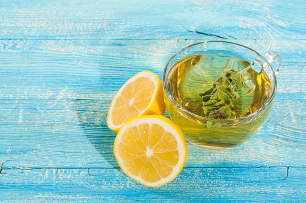 Herbal sage tea with lemon on wooden
