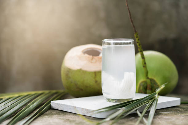 Coconut water with coconuts in the background