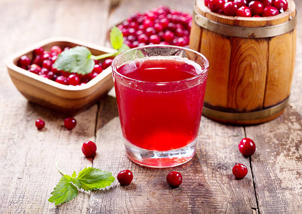 Healthy cranberry juice with ripe berry fruits on the side