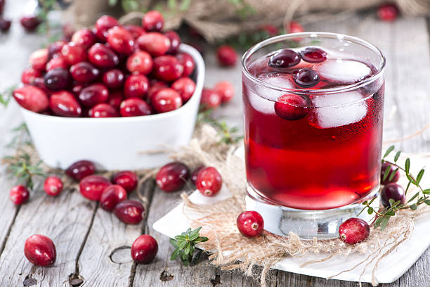  Cranberry Juice in a glass with cranberry fruits on the side