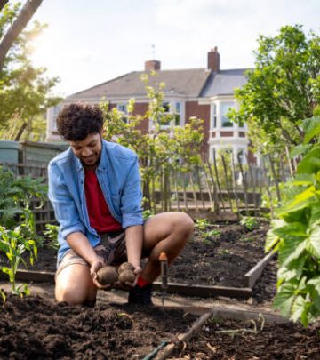 Boy farmer monitoring his crops in the garden