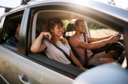 Young couple shares lighthearted moments and laughter during their adventurous car journey