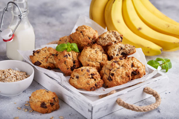 Chewy choc-banana cookies with oat flakes, bananas and chocolate. Delicious homemade biscuits served with milk.