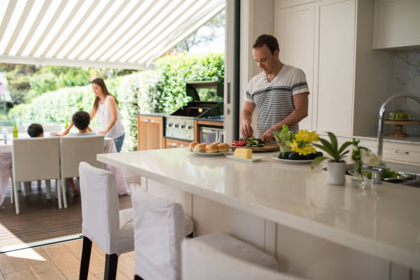 Family preparing lunch. Family preparing grill. Family have lunch on terrace.