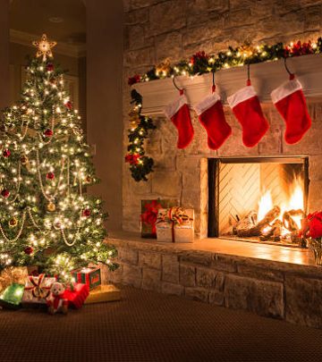 Glowing Christmas fireplace and living room, with tree, and stockings hanging from mantel by fireplace.Waiting for Santa.