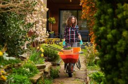 woman taking her tools down the garden