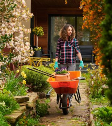 woman taking her tools down the garden