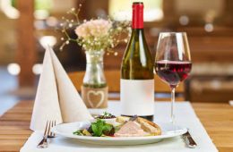 Boar pate with vegetables and plum jam and red wine in a restaurant