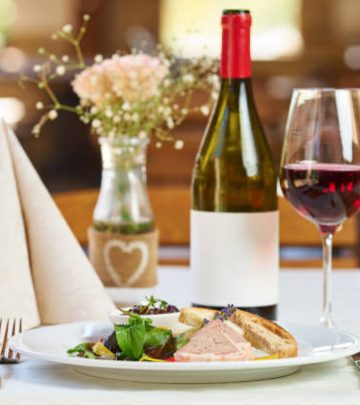 Boar pate with vegetables and plum jam and red wine in a restaurant