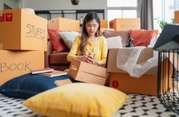 happiness young adult asian female Woman packing things into boxes prepare moving from old place to new home with cheerful and happiness,home moving house booming ideas concept