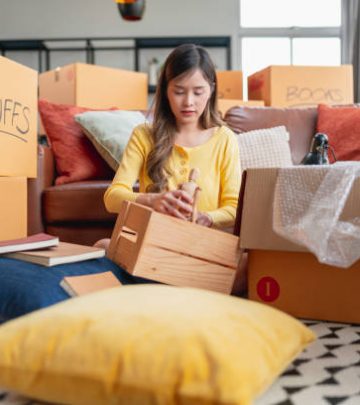 happiness young adult asian female Woman packing things into boxes prepare moving from old place to new home with cheerful and happiness,home moving house booming ideas concept