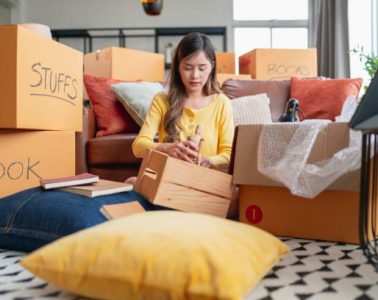 happiness young adult asian female Woman packing things into boxes prepare moving from old place to new home with cheerful and happiness,home moving house booming ideas concept