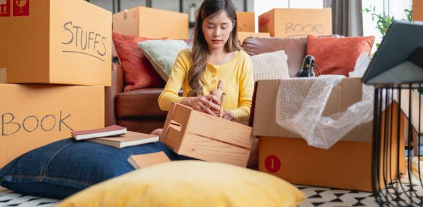 happiness young adult asian female Woman packing things into boxes prepare moving from old place to new home with cheerful and happiness,home moving house booming ideas concept