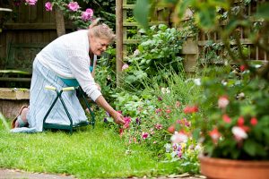 Grandma using a garden stool/kneeler for her garden duties