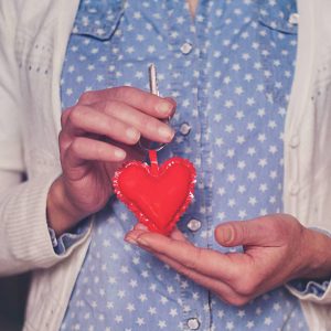 woman holding heart shaped key chain