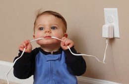 baby boy chews on an electrical cord.