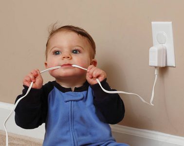 baby boy chews on an electrical cord.