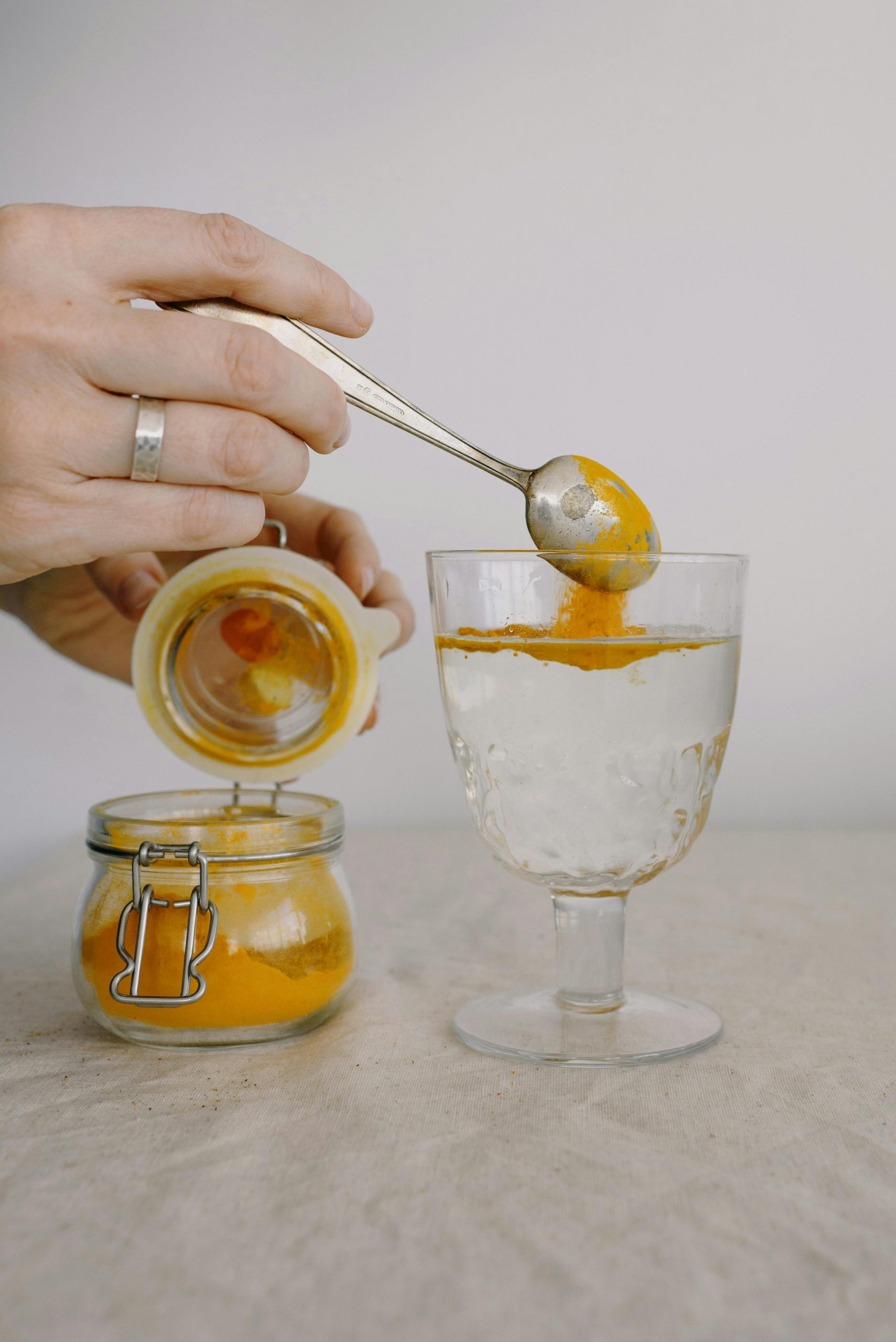 Pouring turmeric powder for using it 