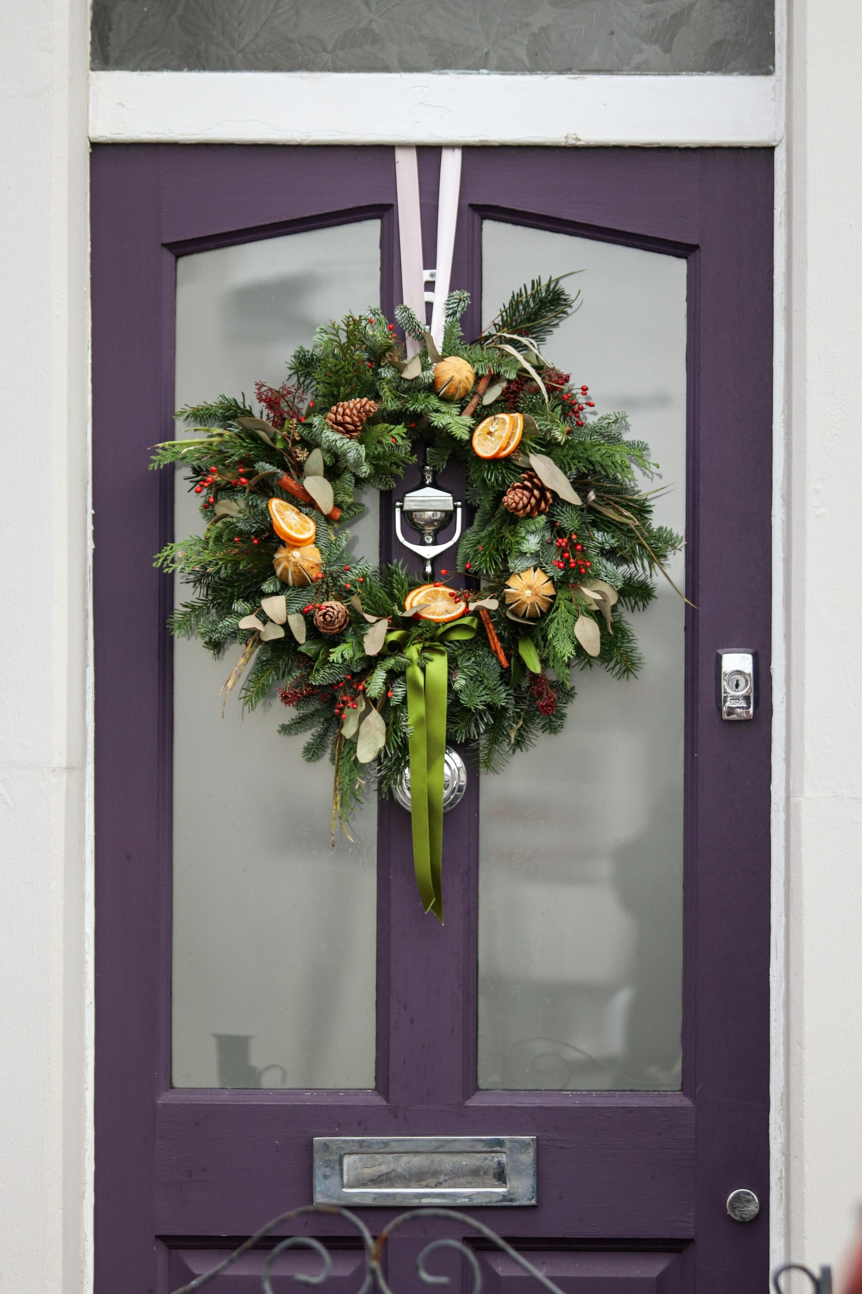 Wreath hanged by a ribbon on a front door